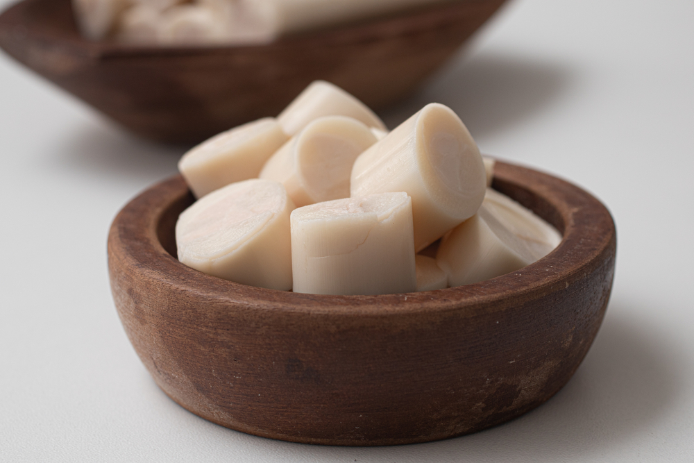 Sliced palm heart in a bowl on a white background